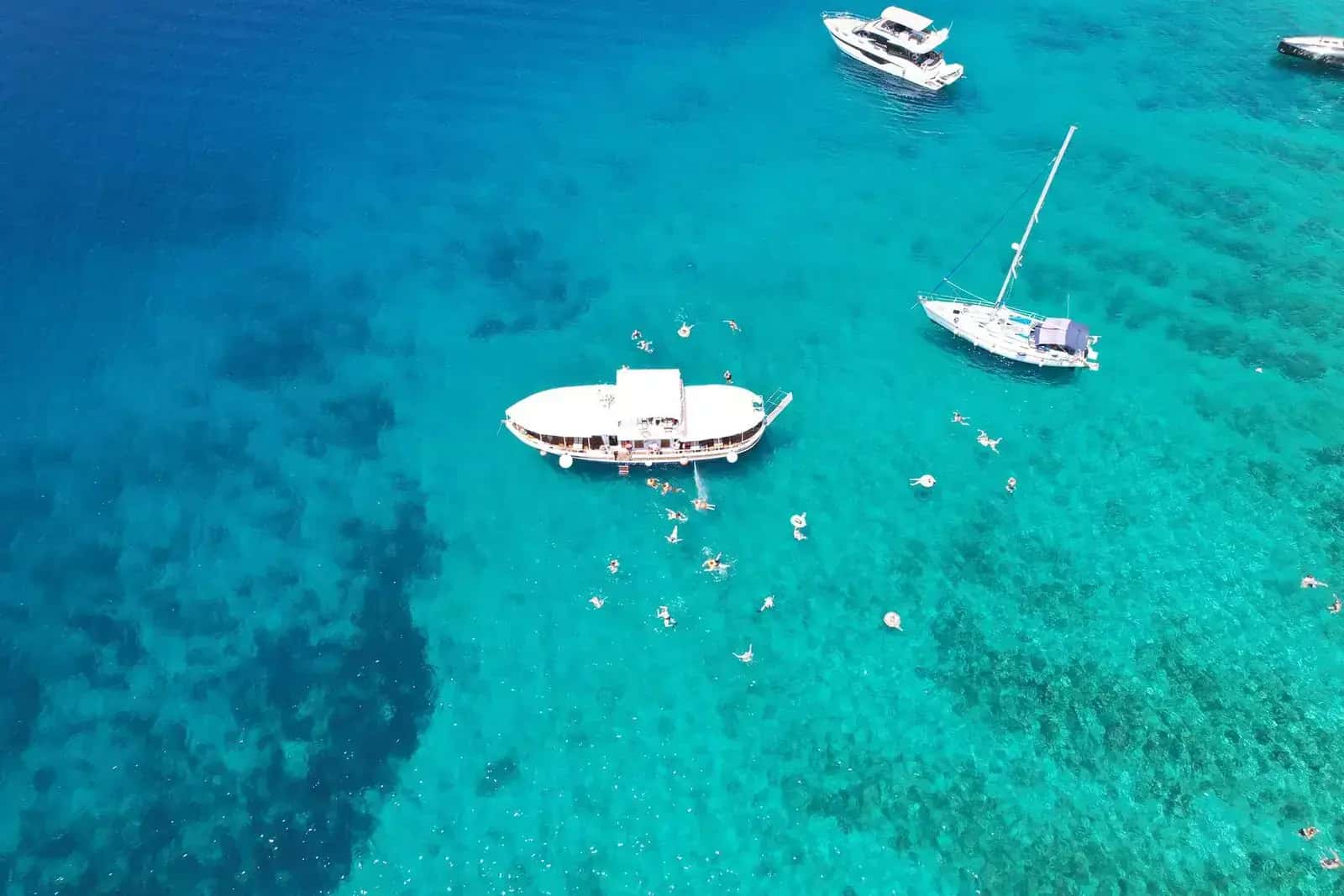 20-meter traditional wooden boat with canopy sun deck moored at Stobreč Harbor, ready for Blue Lagoon tour departures